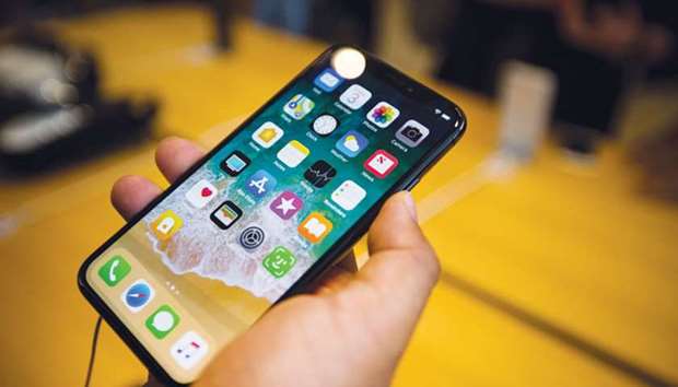 A customer holds an iPhone X during its sales launch in New York on November 3. Apple is evaluating a different technology from the one it currently uses in the TrueDepth sensor system on the front of the iPhone X, say sources.