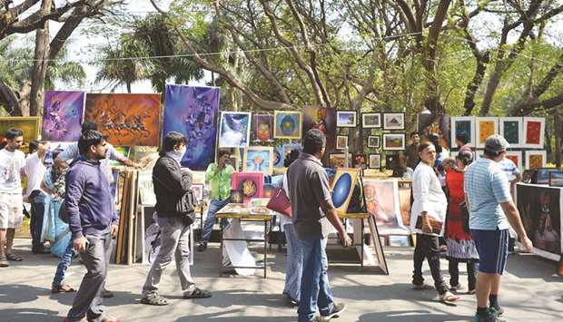 This file photo taken on January 15, 2017 shows visitors walking through exhibitions at the annual u2018Chitra Santheu2019 art fair in Bengaluru.
