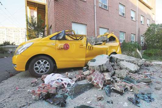 A car damaged by falling bricks is abandoned in the South Korean port city of Pohang.