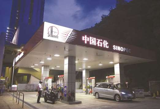 Vehicles refuel at a Sinopec gas station in Hong Kong. Chinese oil refiners, including Sinopec, are churning out record amounts of fuel in the last quarter of 2017, looking to cash in on the best refining profits in nearly two years after a rally in diesel and gasoline prices. Officials at five state-owned oil processors said they are refining and shipping as much product as possible after receiving generous export quotas.