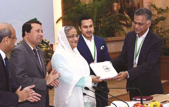 Bangladeshu2019s leading leather entrepreneur Syed Nasim Manzur presents a leader product to Prime Minister Sheikh Hasina in Dhaka yesterday.