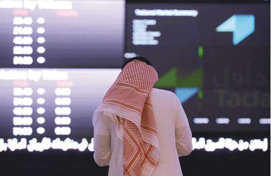 A Saudi investor monitors shares prices at the Saudi Stock Exchange, or Tadawul, in the capital Riyadh (file). The Capital Market Authority is asking brokerages to suspend the accounts of dozens of princes, billionaires and officials being held so theyu2019re unable to buy or sell shares on the Tadawul, according to three people familiar with the matter.
