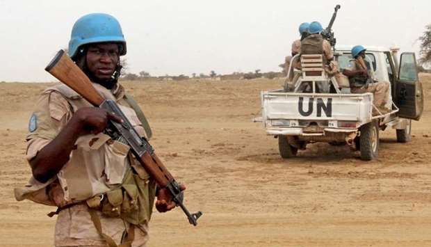UN peacekeepers stand guard in the northern town of Kouroume, Mali