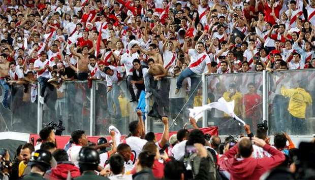 Peruvian players celebrate after defeating New Zealand by 2-0 and qualifying for the 2018 football World Cup