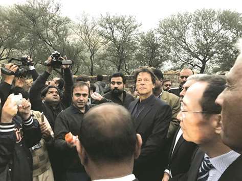 PTI chairman Imran Khan is seen with members of the media  during the unveiling ceremony of the Buddhist-period  archaeological site near Haripur, in Khyber Pakhtunkhwa.