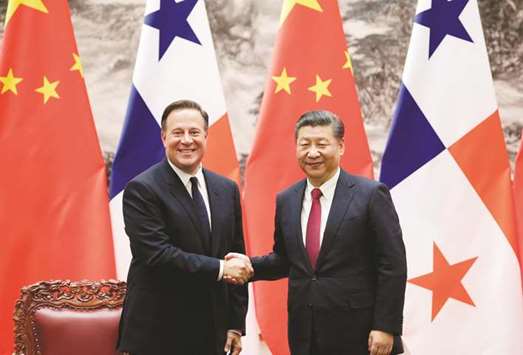 Panamau2019s President Juan Carlos Varela (left) shakes hands with Chinau2019s President Xi Jinping during a signing ceremony in Beijing yesterday. Varela met with Xi one day after Panama opened its first embassy in China, five months after cutting ties with Taiwan.