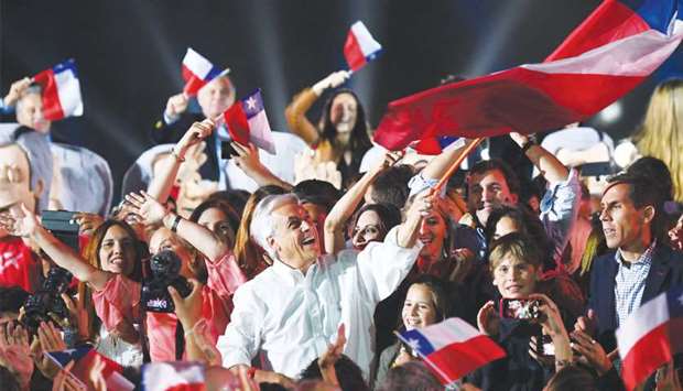 Chilean presidential candidate Sebastian Pinera waves a Chilean national flag during his final rally in Santiago.