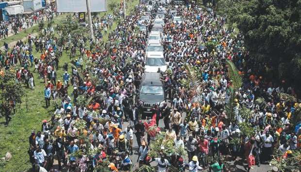 Supporters of Raila Odinga march with his convoy upon his arrival from the Jomo Kenyatta International Airport.
