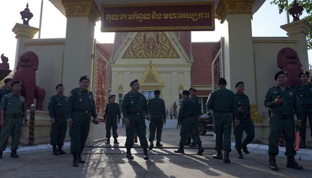 Cambodian police officials stand guard during a hearing in front of the Supreme Court building in Phnom Penh.