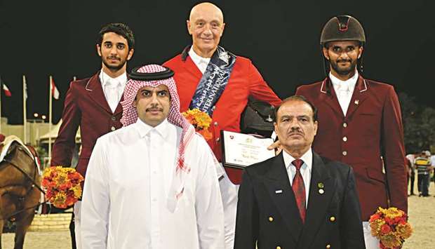 Winner Vladimir Tuganov (background centre), second-placed Salmeen Sultan al-Suwaidi (left) and third-placed Hamad al-Attiyah pose with QEF president Hamad Al Attiyah (front left) and Col. Usman Nasir, Executive Board Member of Equestrian Federation of Pakistan. PICTURE: Lotfi Garsi