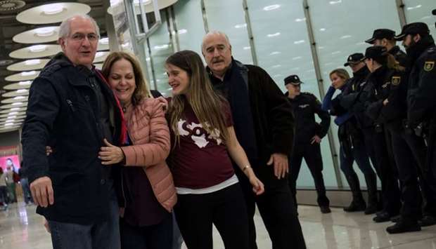 Antonio Ledezma, Venezuelan opposition leader (L), walks with his wife Mitzy Capriles and daughter Antonietta upon arriving at Adolfo Suarez Madrid Barajas airport in Madrid, Spain.