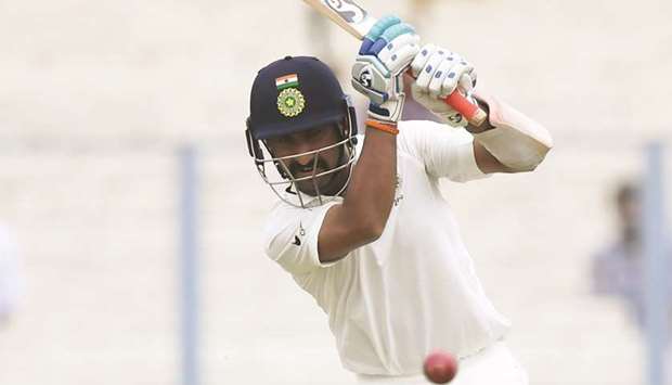 Indiau2019s Cheteshwar Pujara plays a shot during the second day of first Test against Sri Lanka at Eden Gardens in Kolkata yesterday. (AFP)