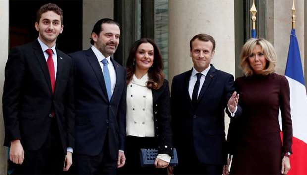 French President Emmanuel Macron and his wife Brigitte Macron, Saad al-Hariri, who announced his resignation as Lebanon's prime minister while on a visit to Saudi Arabia, his wife Lara and their son Houssam are pictured at the Elysee Palace in Paris, France