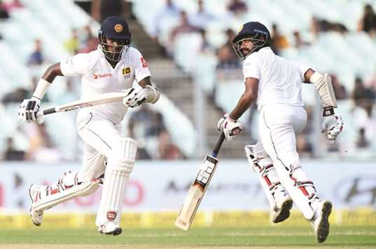 Sri Lankau2019s Angelo Mathews (left) and Lahiru Thirimanne run between the wickets during the third day of the first Test against India at Eden Gardens in Kolkata. (AFP)