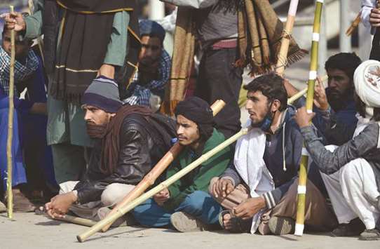 Members of the religious movement blocking a highway to Islamabad eye riot police during a protest yesterday.
