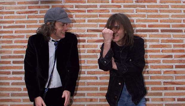 (This file photo taken on March 22, 2000 shows Australian guitarists and brothers Angus (left) and Malcolm Young of the hard rock group AC/DC inaugurating the first street in the world bearing their groupu2019s name in Leganes, 29km from Madrid. AC/DC guitarist and cofounder Malcolm Young has died aged 64, the band announced yesterday.