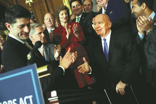 Speaker of the House Paul Ryan celebrates the passage of the u2018Tax Cuts and Jobs Actu2019 with Representative Kevin Brady (R-TX) during a news conference at the US Capitol in Washington.
