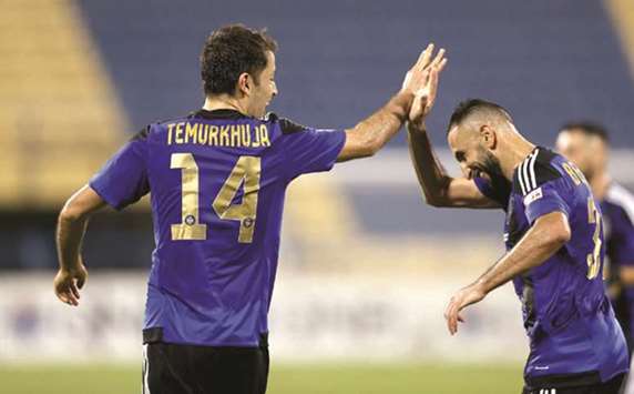 Al Sailiyau2019s Temurkhuja Abdukholiqov (left) and teammate Nadir Belhadj celebrate a goal during their QNB Stars League match against Al Gharafa yesterday. PICTURE: Anas Khalid