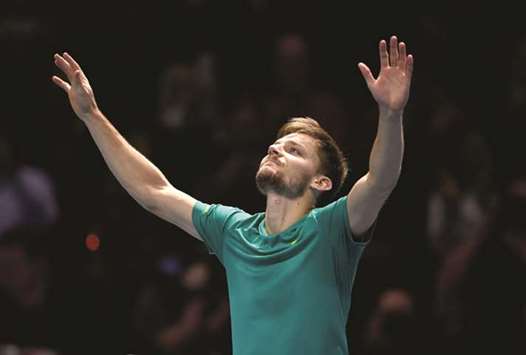 Belgiumu2019s David Goffin celebrates his win over Roger Federer (below) in the ATP Tour Finals semi-final yesterday. (Reuters)