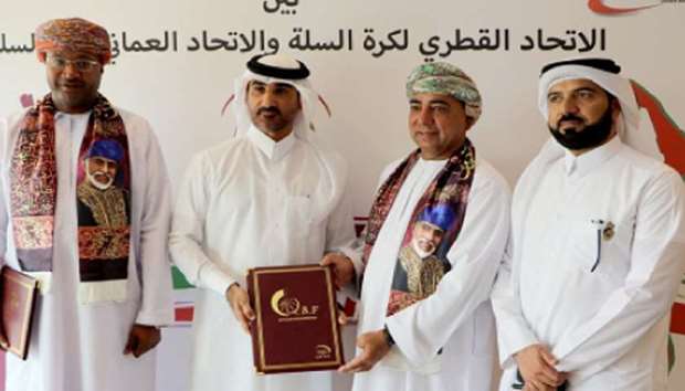 Qatar Basketball Federation President Ahmed al-Muftah (second from left) and Oman Basketball Association Chairman Farid al-Zadjali (third from left) sealing a co-operation agreement between the two federations yesterday. According to the agreement, Qatar and Oman will seek to develop the game of basketball by holding regular competitions between their menu2019s teams besides improving technical expertise through regular interaction between referees and other officials. QBF General Secretary Ali al-Malki (extreme right) and Oman Basketball Association General Secretary Assad al-Hasani (extreme left) are also seen in the picture.