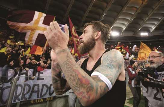 Romau2019s Daniele De Rossi celebrates in front of fans after the match.