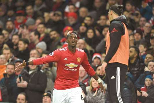 Manchester Unitedu2019s French midfielder Paul Pogba (L) greets Swedish striker Zlatan Ibrahimovic (R) as Pogba leaves the pitch substituted during their English Premier League football match against Newcastle United at Old Trafford in Manchester yesterday.