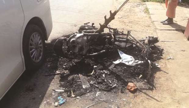 A burned motorbike on a street following the violence in Galle yesterday.