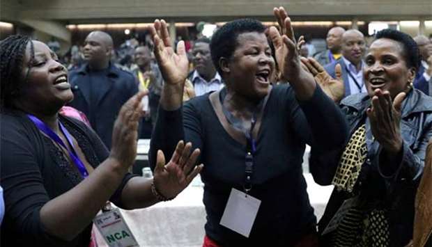 Delegates celebrate after Zimbabwean President Robert Mugabe was dismissed as party leader at an extraordinary meeting of the ruling ZANU-PF's central committee in Harare on Sunday.