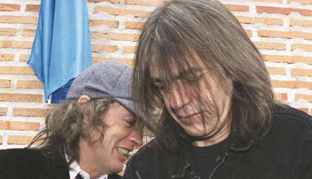 In this file picture, Australian guitarists and brothers Angus (left) and Malcolm Young of the hard rock group AC/DC inaugurating the first street in the world bearing their groupu2019s name in Leganes, 29km from Madrid.