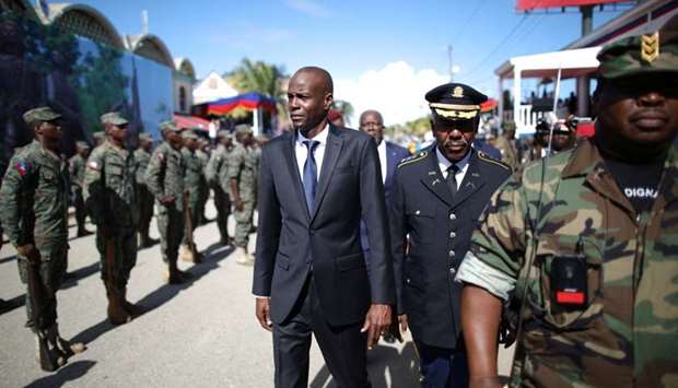 Haitian President Jovenel Moise (C) and acting Chief of the army's high command Jodel Lesage inspect the troops before a parade of the Haitian Armed Forces (FAD'H) in the streets of Cap-Haitien,