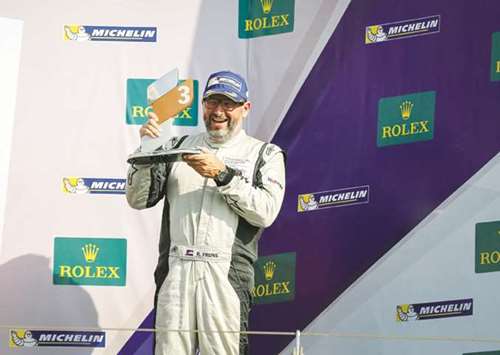 Rob Frijns celebrates on the podium after finishing third in race two of the round one of the Porsche GT3 Cup Challenge Middle East.