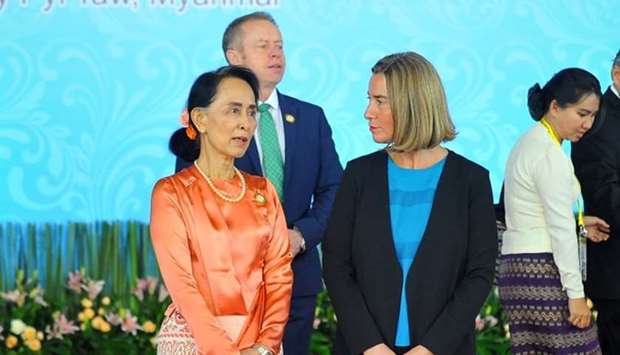 Myanmar's State Councellor and Foreign Minister Aung San Suu Kyi (L) speaks with EU Foreign Policy Representative Federica Mogherini (R) after a family photo during the 13th Asia-Europe (ASEM) foreign ministers' meeting in Naypyidaw.