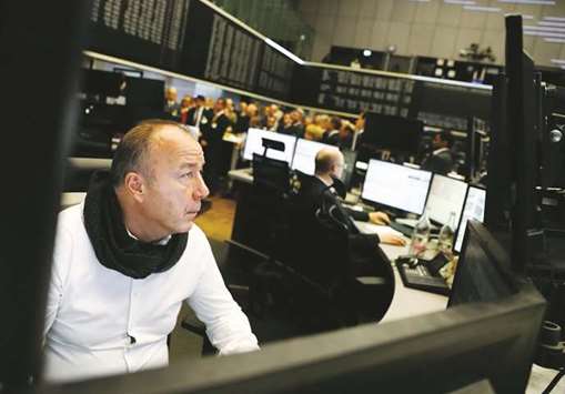 A share trader checks his screens at the Frankfurt Stock Exchange. At the close of trading yesterday, Frankfurtu2019s DAX 30 index was up 0.5% at 13,058.66.