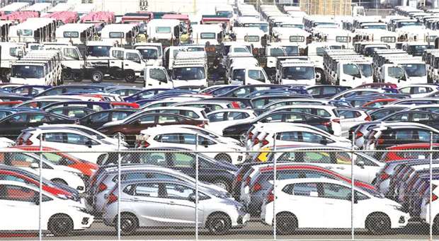 Newly manufactured cars await export at a port in Yokohama. Ministry of Finance (MOF) data yesterday showed that Japanu2019s exports rose 14% year-on-year in October, led by shipments of cars to Australia and liquid-crystal device production equipment and raw materials for plastics to China.