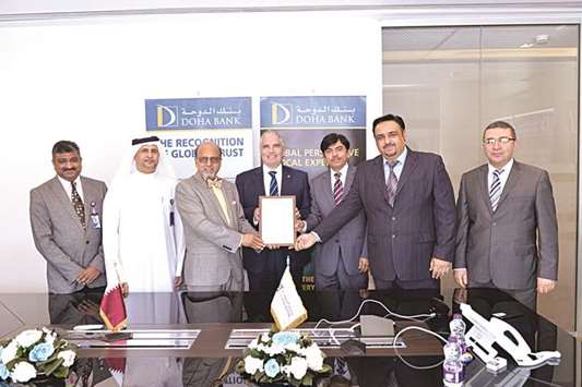 Dr Seetharaman and other senior Doha Bank officials at the certification ceremony.