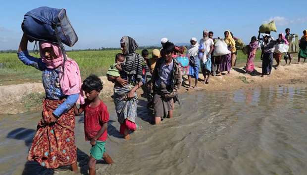 Rohingya refugees walk towards a refugee camp after crossing the border in Anjuman Para near Cox's Bazar, Bangladesh.