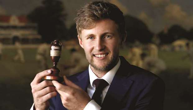 Englandu2019s Joe Root poses with the Ashes urn in this file photo.