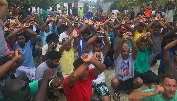 Refugees gesturing inside the Manus detention camp in Papua New Guinea