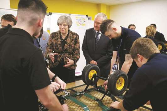 Prime Minister Theresa May visits an engineering training facility in the West Midlands yesterday.