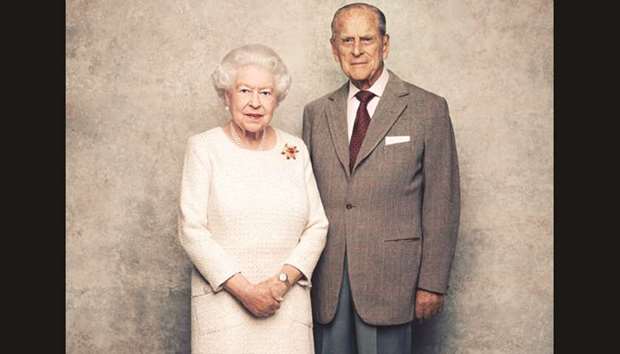 Queen Elizabeth and Prince Philip pose for a picture in the White Drawing Room at Windsor Castle in celebration of their platinum wedding anniversary yesterday.