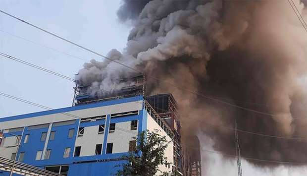 Smoke billows from a coal-fired power plant after a boiler unit exploded in the town of Unchahar