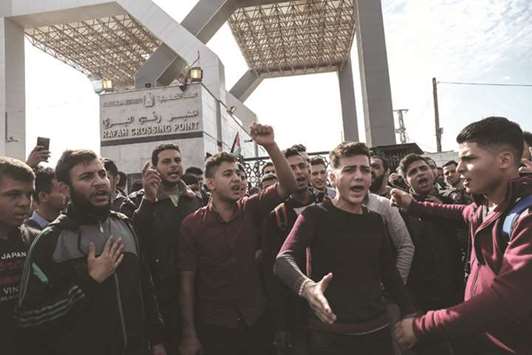 Palestinian students shout outside the Rafah border crossing with Egypt before being allowed to pass out of the southern Gaza Strip yesterday.