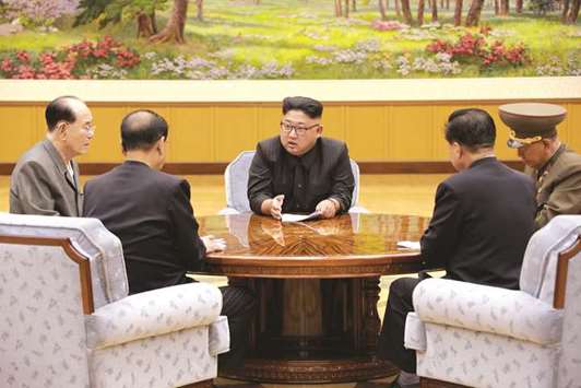 North Korean leader Kim Jong-un participates in a meeting with top officials. Experts say the designation will be largely symbolic as North Korea is already heavily sanctioned by the United States.