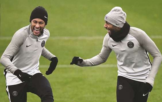 Paris Saint-Germain forward Neymar (left) jokes with teammate Lucas during training in Paris yesterday. (AFP)