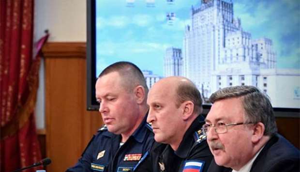 Russian Foreign Ministry's security and disarmament department head Mikhail Ulyanov (right) along with others holds a briefing on the UN report, in Moscow on Thursday.