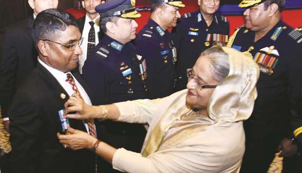 Prime Minister decorating an army officer with gallantry award in Dhaka yesterday.