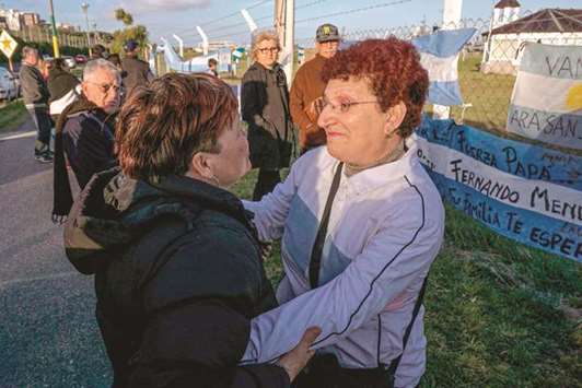 Maria Rosa Belenstro (right), mother of missing submariner Fernando Villareal, is comforted by a local woman outside the navy base in Mar del Plata.
