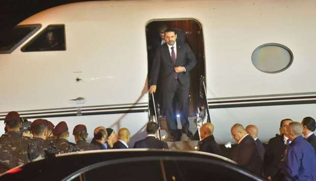 Lebanese Prime Minister Saad Hariri (C) arrives at Beirut International Airport late yesterday.