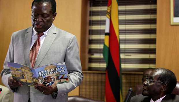 Zimbabwe's President Robert Mugabe looks on as his deputy Emmerson Mnangagwa reads a card during Mugabe's 93rd birthday celebrations in Harare, Zimbabwe on February 21, 2017.