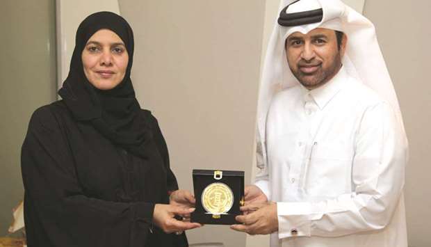 Dr Khalid bin Ibrahim al-Sulaiti receiving the award from Dr Hamda Hassan al-Sulaiti.